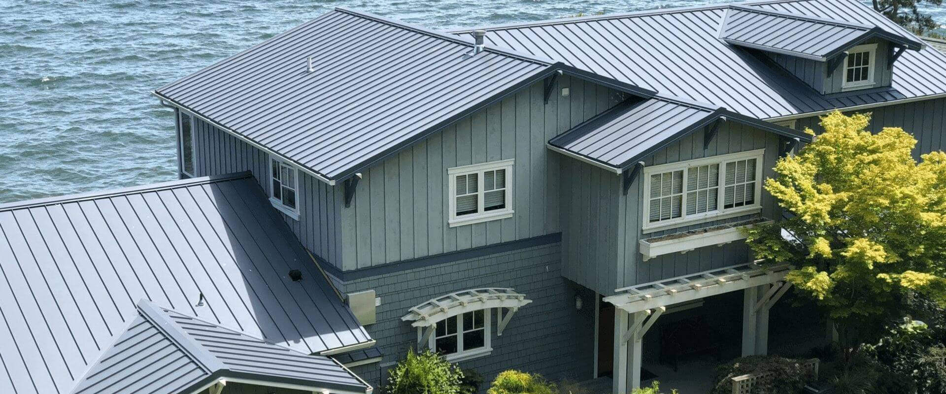 front view of home with a blue standing seam metal roof